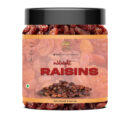Plump black midnight raisins in wooden bowl