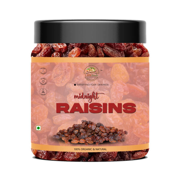 Plump black midnight raisins in wooden bowl
